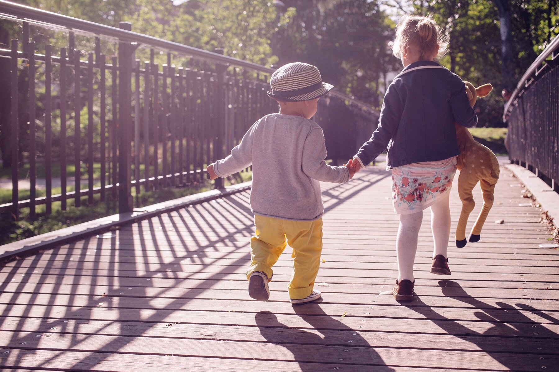 cute kids holding hands on a bridge. Their parents got anxiety treatment in Roseville, CA with the relationship therapy center who also offers anxiety treatment in Fair Oaks, CA